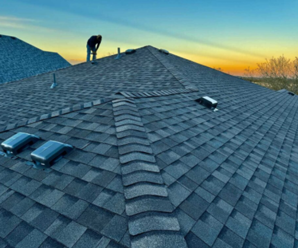 Completed residential asphalt shingle roofing system on modern house roof